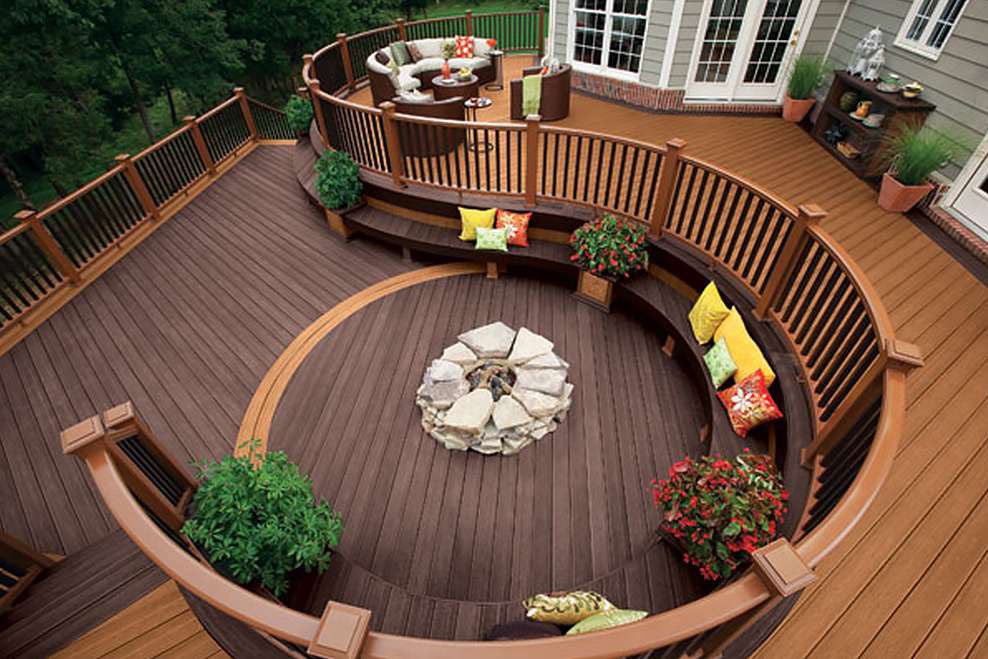 Curved multi-level dream deck with stone fire pit and built-in seating